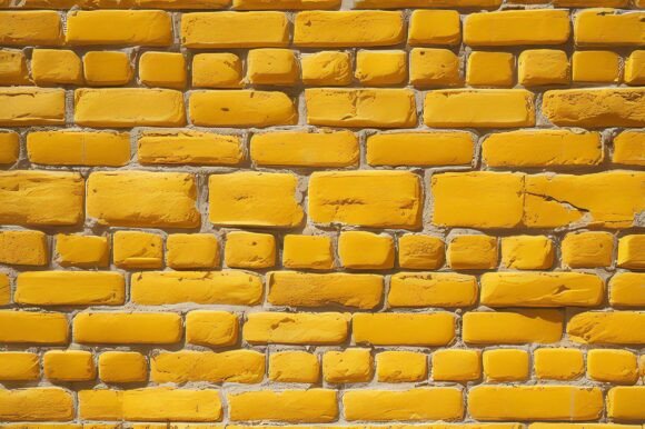 A Yellow Brick Wall with White Cement